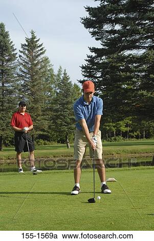 Two men playing golf View Large Photo Image Stock Image - Two men playing golf. Fotosearch