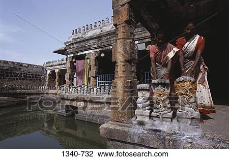 Two women worshipping in a temple, Naganathaswamy Temple, Peraiyur, Madurai District, Tamil Nadu, India View Large Photo Image Stock Image - Two women worshipping in a temple, Naganathaswamy Temple, Peraiyur, Madurai District, Tamil Nadu, India. Fotosearch