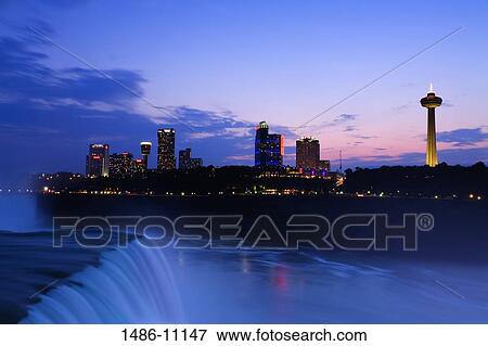 Waterfall with buildings lit up at dusk, American Falls, Niagara Falls, City of Niagara Falls, New York State, USA View Large Photo Image Stock Photo - Waterfall with buildings lit up at dusk, American Falls, Niagara Falls, City of Niagara Falls, New York State, USA. Fotosearch