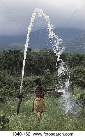 Woman collecting water from a borewell, Attappadi, Palakkad District, Kerala, India View Large Photo Image Stock Image - Woman collecting water from a borewell, Attappadi, Palakkad District, Kerala, India. Fotosearch