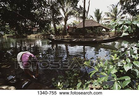 Woman washing fish in water, Kerala, India View Large Photo Image Stock Photography - Woman washing fish in water, Kerala, India. Fotosearch
