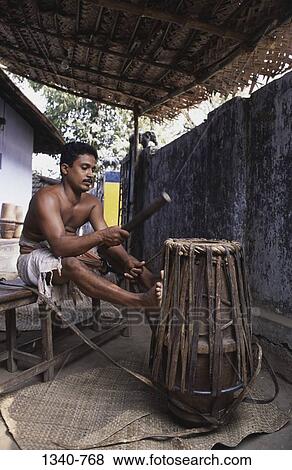 Young man making a Jendai a drum like leather musical instrument, Peruvemba, Palakkad, Kerala, India View Large Photo Image Stock Photo - Young man making a Jendai a drum like leather musical instrument, Peruvemba, Palakkad, Kerala, India. Fotosearch