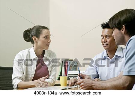 Stock Image - Business executives in a meeting. Fotosearch