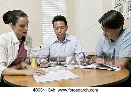 Stock Image - Business executives in a meeting. Fotosearch