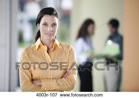 Businesswoman standing in an office View Large Photo Image Stock Photo - Businesswoman standing in an office. Fotosearch