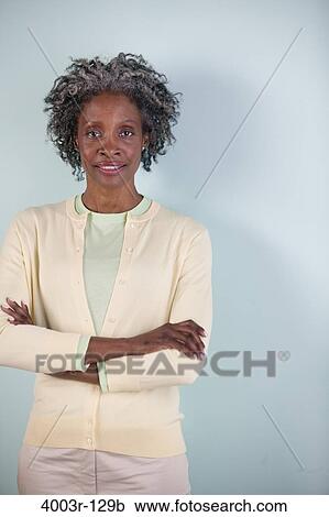 Stock Image - Businesswoman standing with her arms crossed. Fotosearch
