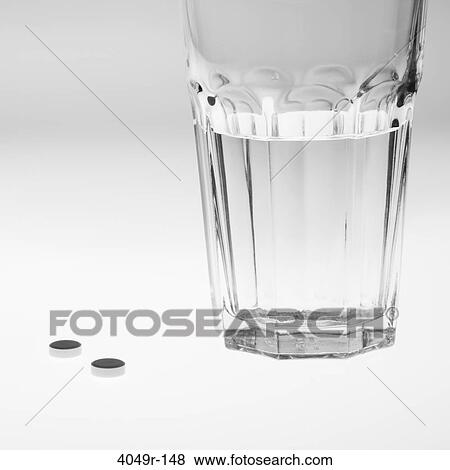 Close-up of a glass of water with pills View Large Photo Image Stock Photo - Close-up of a glass of water with pills. Fotosearch