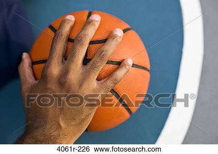 Close-up of a man's hand on a basketball View Large Photo Image Stock Photograph - Close-up of a man's hand on a basketball. Fotosearch