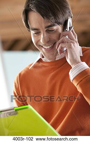 Close-up of a mid adult man talking on a mobile phone View Large Photo Image Stock Image - Close-up of a mid adult man talking on a mobile phone. Fotosearch