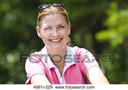 Close-up of a mid adult woman smiling View Large Photo Image Stock Photo - Close-up of a mid adult woman smiling. Fotosearch
