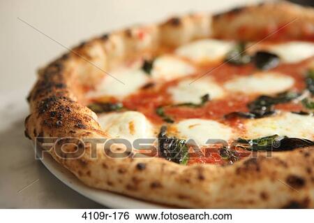 Close-up of a whole pizza pie View Large Photo Image Stock Photograph - Close-up of a whole pizza pie. Fotosearch
