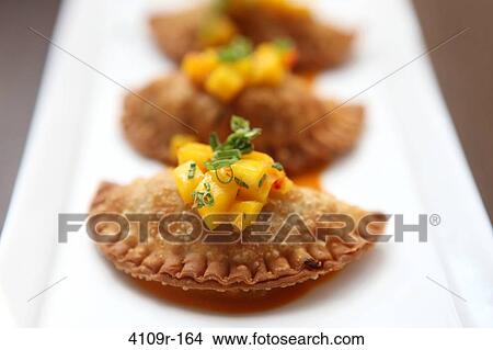 Picture - Close-up of Cuban empanadas served in a plate. Fotosearch