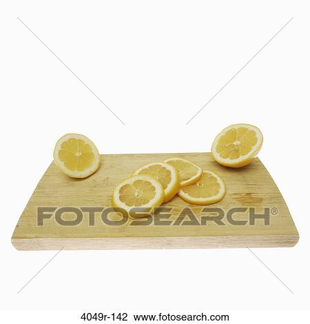 Close-up of lemon slices on a cutting board View Large Photo Image Stock Image - Close-up of lemon slices on a cutting board. Fotosearch