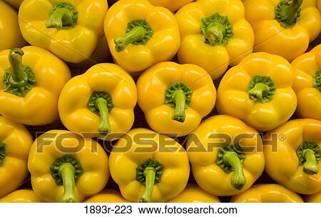 Stock Image - Close-up of yellow bell peppers at a supermarket. Fotosearch