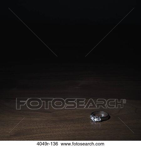 Diamond ring on a table View Large Photo Image Stock Photograph - Diamond ring on a table. Fotosearch