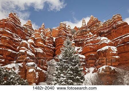 Stock Image - Low angle view of snowy rocks, Red Canyon State Park, Utah, USA. Fotosearch
