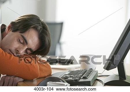Mid adult man napping on a desk View Large Photo Image Picture - Mid adult man napping on a desk. Fotosearch