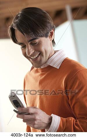 Mid adult man text messaging on a mobile phone View Large Photo Image Stock Image - Mid adult man text messaging on a mobile phone. Fotosearch