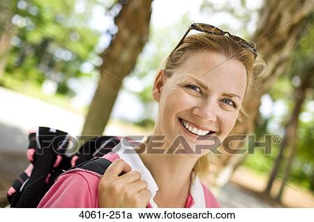 Mid adult woman carrying a golf bag View Large Photo Image Stock Image - Mid adult woman carrying a golf bag. Fotosearch