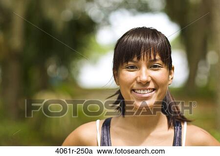 Portrait of a young woman smiling View Large Photo Image Stock Image - Portrait of a young woman smiling. Fotosearch