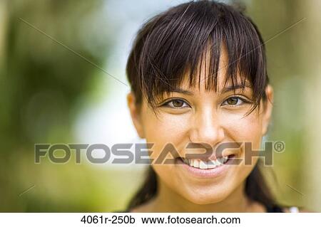 Stock Image - Portrait of a young woman smiling. Fotosearch