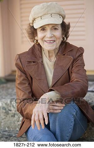 Senior woman sitting in the porch and smiling View Large Photo Image Stock Image - Senior woman sitting in the porch and smiling. Fotosearch
