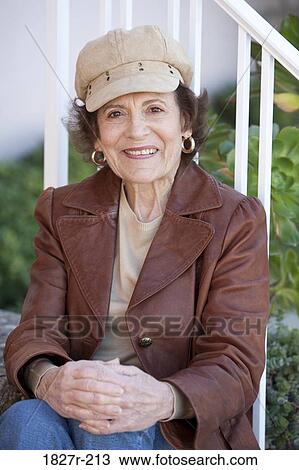 Senior woman sitting in the porch and smiling View Large Photo Image Stock Image - Senior woman sitting in the porch and smiling. Fotosearch