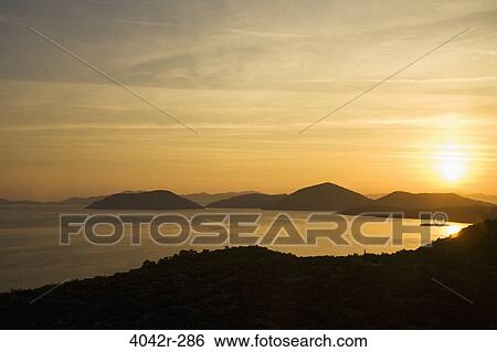 Stock Photograph - Sunset over the sea, Adriatic Sea, Dubrovnik, Dalmatia, Croatia. Fotosearch