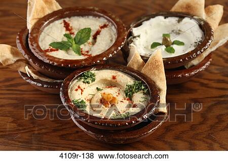 Three bowls of dips with pita slices View Large Photo Image Stock Photo - Three bowls of dips with pita slices. Fotosearch