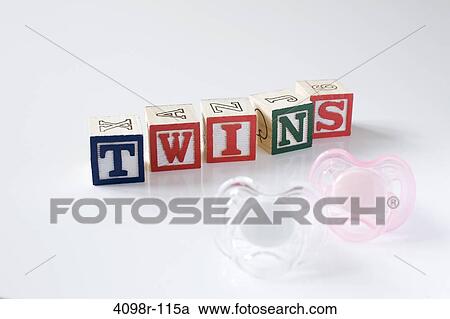 Stock Image - Word TWINS made from alphabetical blocks with pacifiers. Fotosearch
