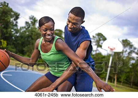 Young couple playing basketball View Large Photo Image Stock Image - Young couple playing basketball. Fotosearch