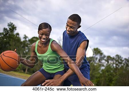 Young couple playing basketball View Large Photo Image Stock Image - Young couple playing basketball. Fotosearch