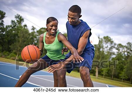 Young couple playing basketball View Large Photo Image Stock Image - Young couple playing basketball. Fotosearch