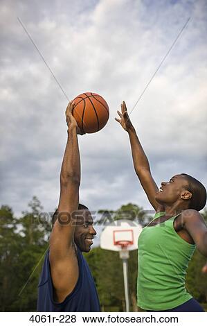 Young couple playing basketball View Large Photo Image Stock Photo - Young couple playing basketball. Fotosearch