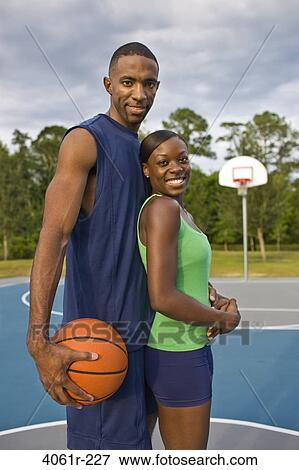 Young couple standing together and smiling View Large Photo Image Stock Photo - Young couple standing together and smiling. Fotosearch