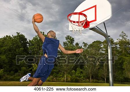 Young man playing basketball View Large Photo Image Stock Photography - Young man playing basketball. Fotosearch