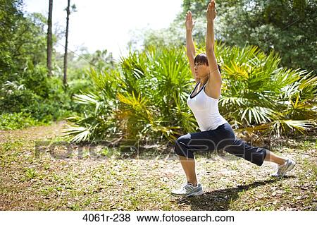 Young woman exercising in a park View Large Photo Image Stock Photo - Young woman exercising in a park. Fotosearch