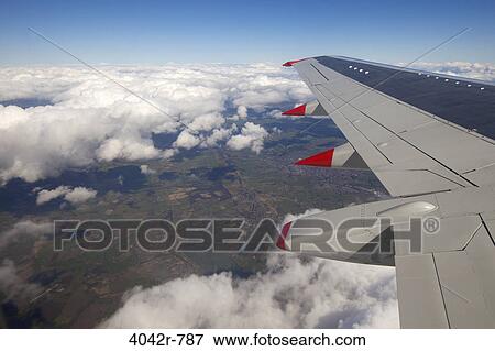 Airplane in flight over islands, Lancashire, England View Large Photo Image Stock Photo - Airplane in flight over islands, Lancashire, England. Fotosearch