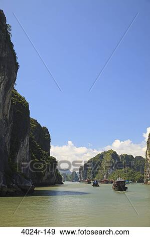 Cliffs in the bay, Halong Bay, Vietnam View Large Photo Image Stock Photo - Cliffs in the bay, Halong Bay, Vietnam. Fotosearch