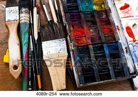 Picture - Paintbrushes with a messy palette on a table, Montmartre, Paris, Isle-De-France, France. Fotosearch