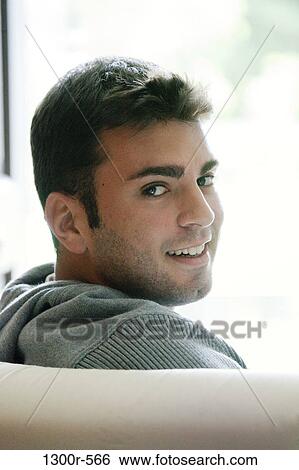Stock Photograph - Portrait of a young man smiling. Fotosearch