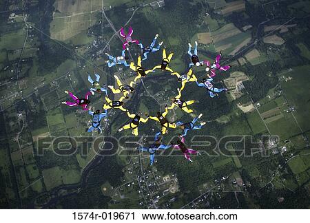 Stock Image - Aerial view of a group of people skydiving. Fotosearch