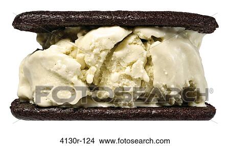 Picture - Close up of ice cream sandwich with chocolate wafer and anise hyssop. Fotosearch