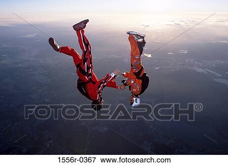 Couple skydiving upside down View Large Photo Image Stock Photo - Couple skydiving upside down. Fotosearch