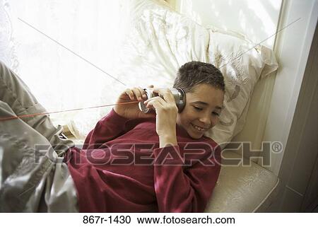 High angle view of a teenage boy playing with string and a can View Large Photo Image Stock Image - High angle view of a teenage boy playing with string and a can. Fotosearch