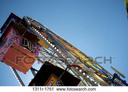 Low angle view of a ferris wheel View Large Photo Image Stock Image - Low angle view of a ferris wheel. Fotosearch