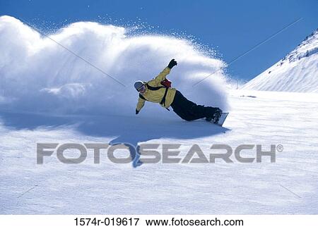 Stock Photo - Low angle view of a man snowboarding. Fotosearch