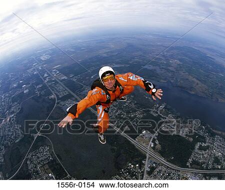 Mid adult man skydiving View Large Photo Image Picture - Mid adult man skydiving. Fotosearch