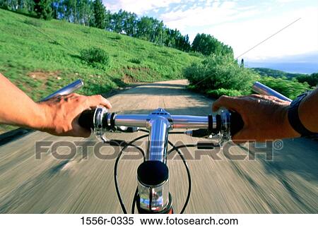 Stock Photography - Person riding bicycle down road. Fotosearch