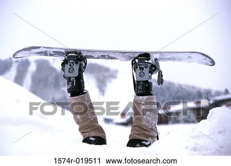 Person upside down in snow strapped to snowboard View Large Photo Image Stock Image - Person upside down in snow strapped to snowboard. Fotosearch